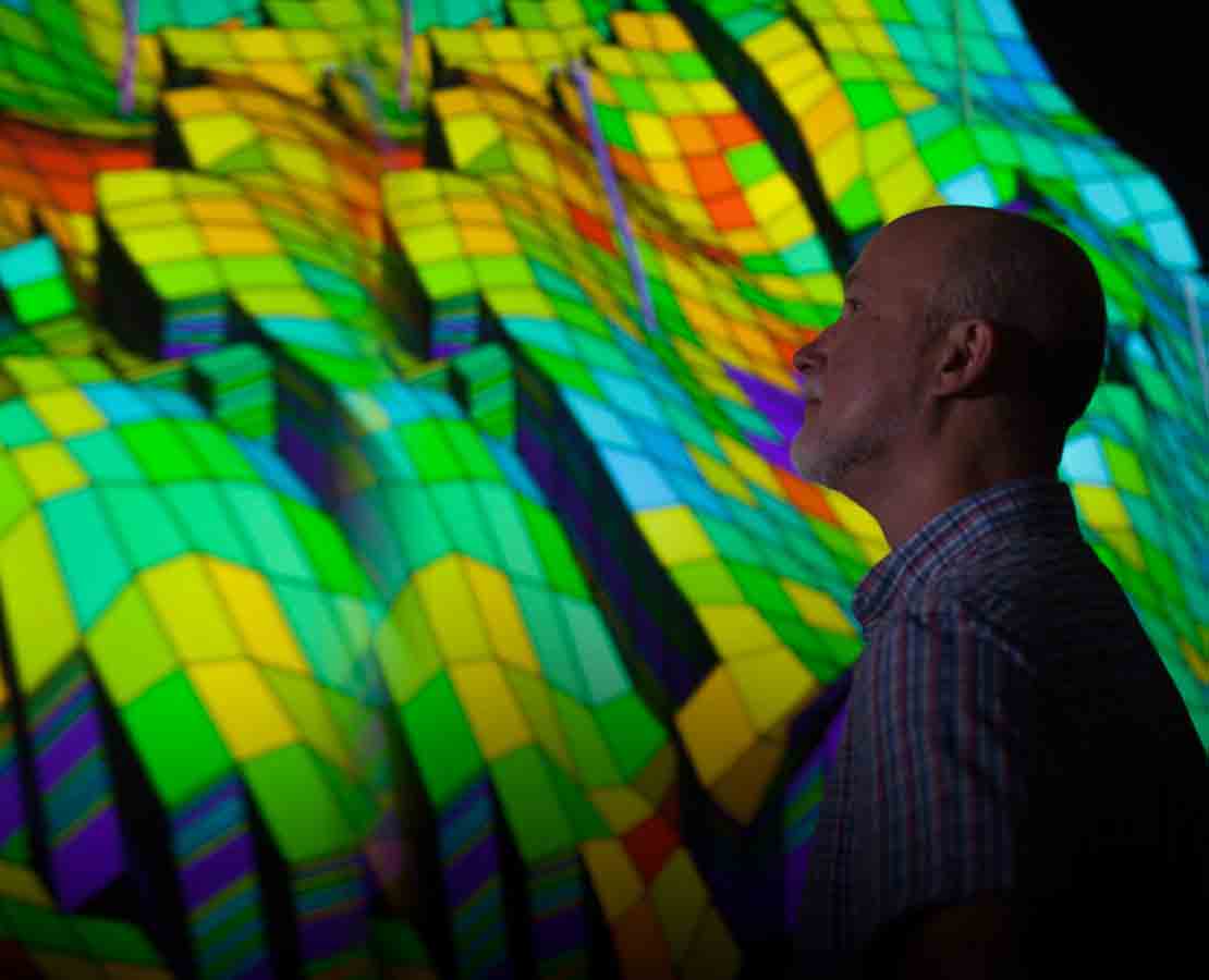 Schlumberger worker looking at image generated by data integration petrophysics services.