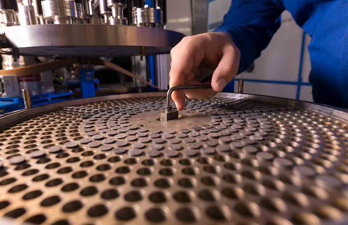 Schlumberger worker performing maintenance on the fluid inclusion technology equipment.