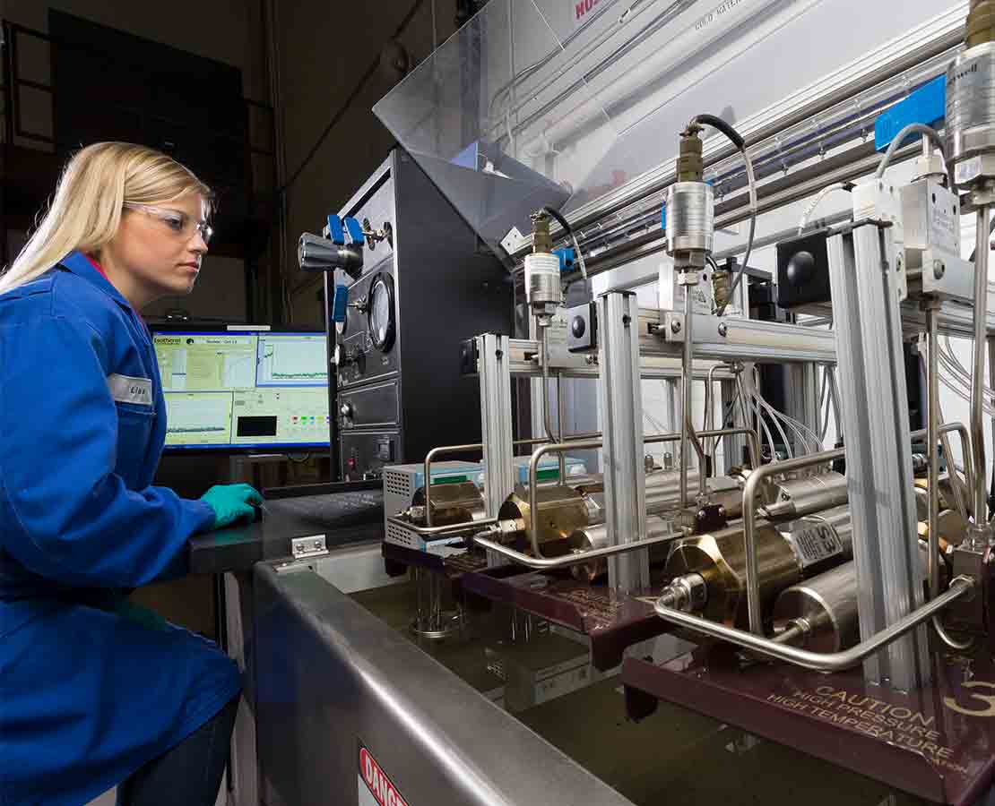 Schlumberger worker in lab performing wellsite core handling and adsorption testing.