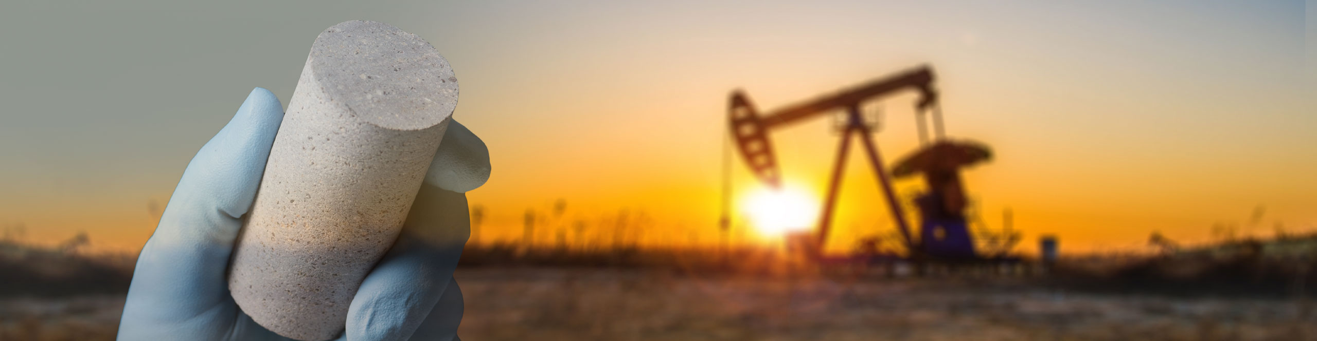 Schlumberger worker's hand holding a core sample overlaid on an image of an artificial lift pump with a sunset.