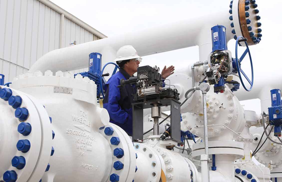 Swing-style Tom Wheatley check valve in a pipeline at a processing facility.