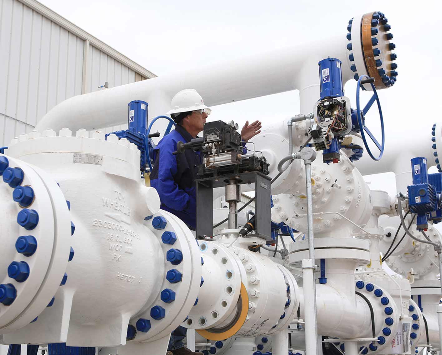 Swing-style Tom Wheatley check valve in a pipeline at a processing facility.
