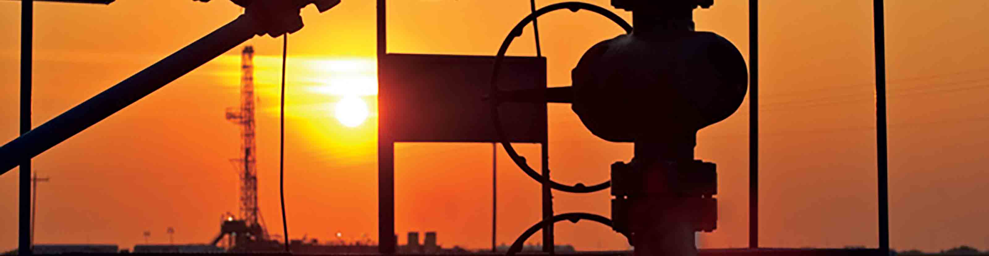 Silhouette of valve equipment at dusk.
