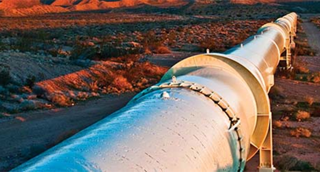 Above-ground pipe in desert location.