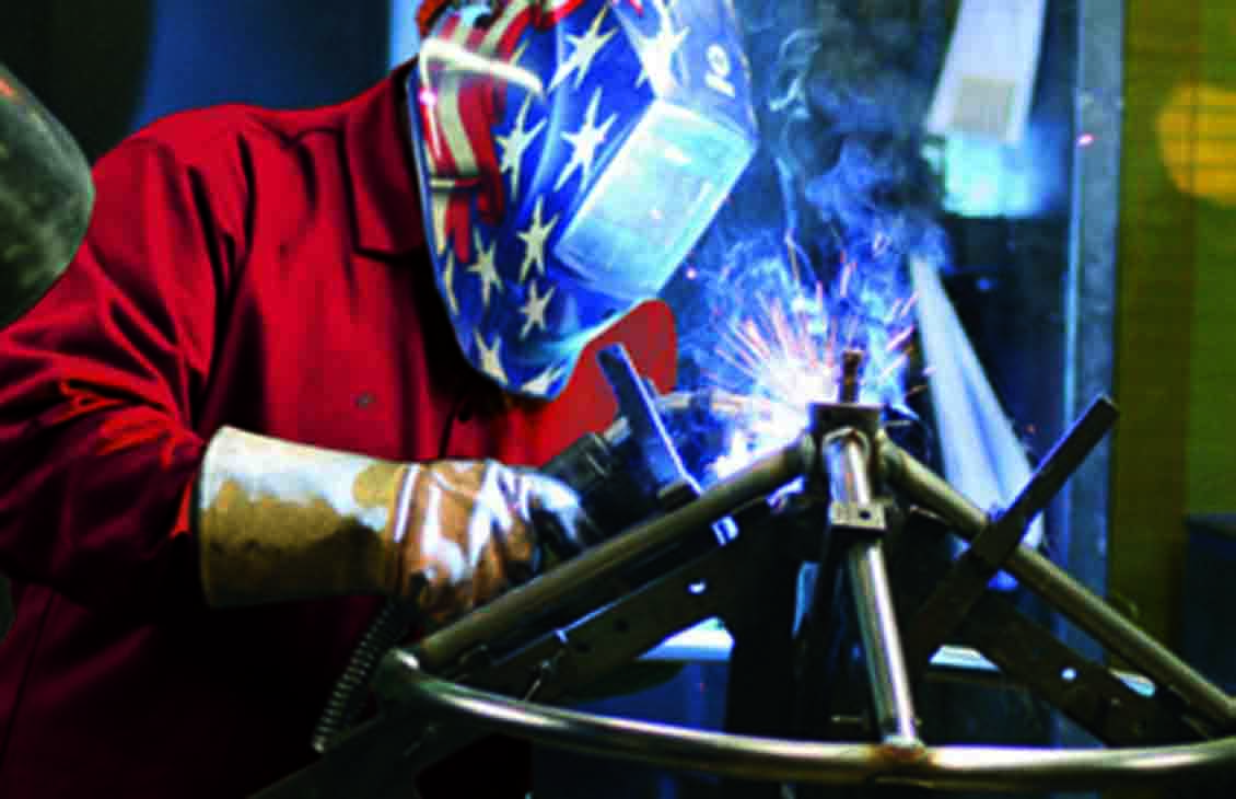 Cameron employee welding a DYNATORQUE handwheel.