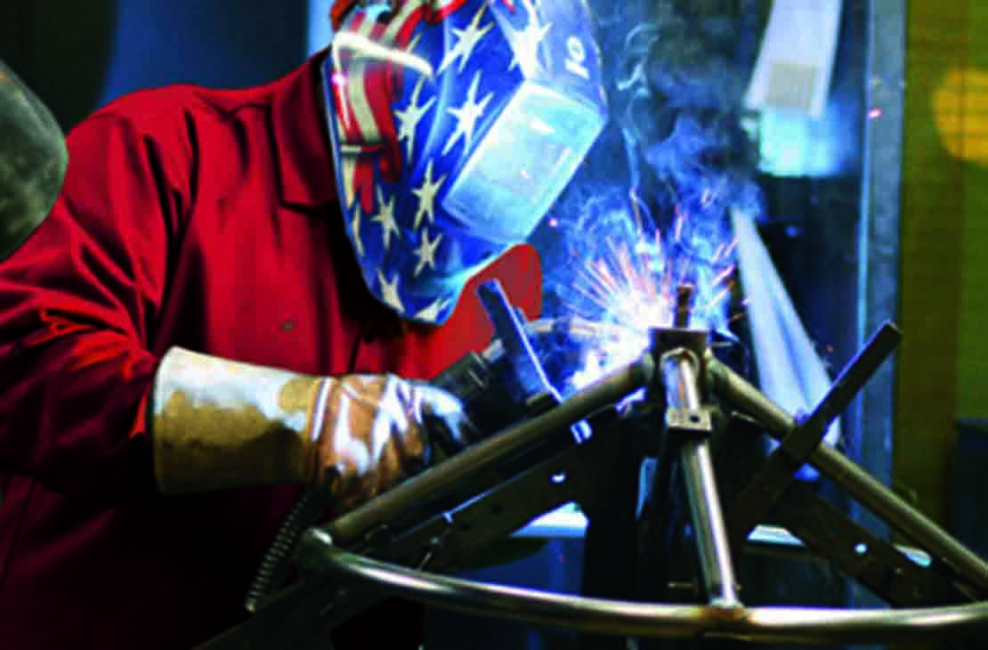 Cameron employee welding a DYNATORQUE handwheel.