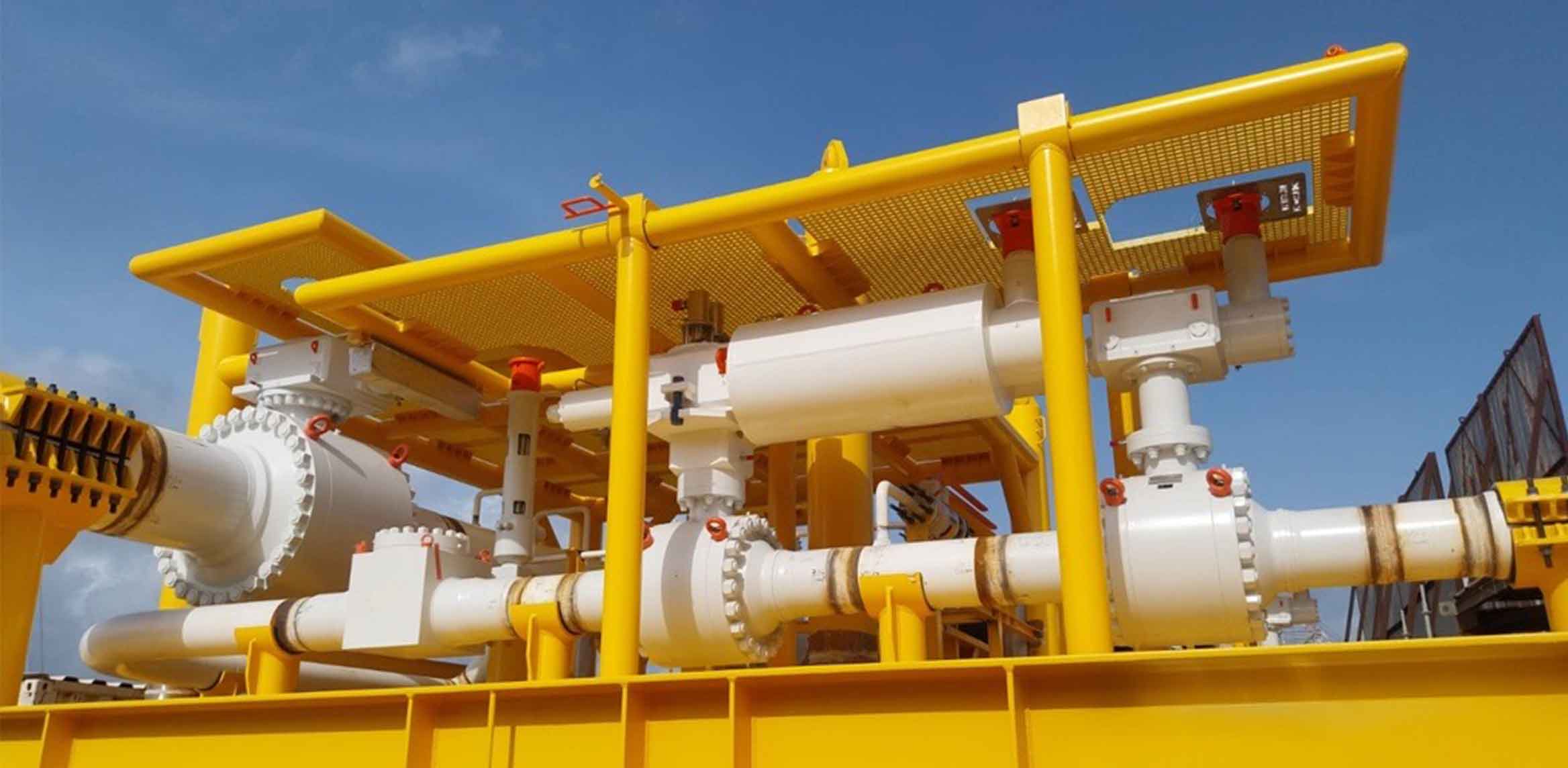 Photograph of subsea skid with SLB ball and check valves operated by Ledeen actuators.