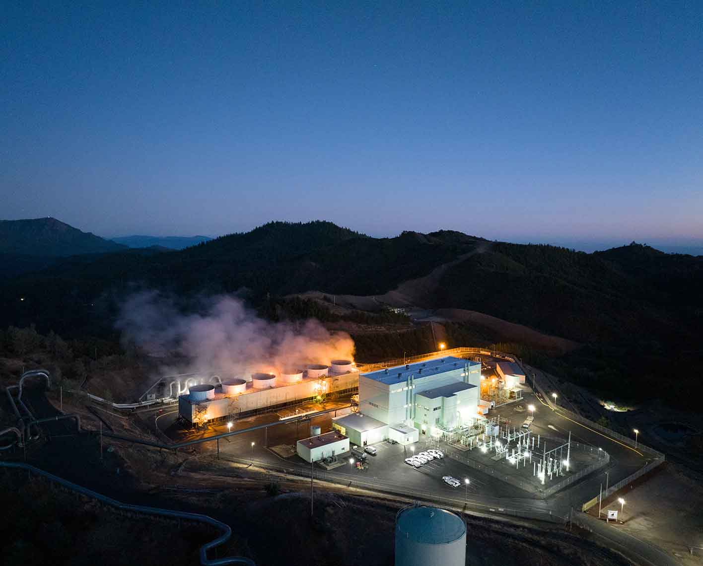 Aerial photo of a geothermal power plant and associated pipelines.
