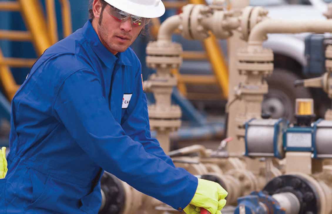 Cameron field technician tightening valve in the field.