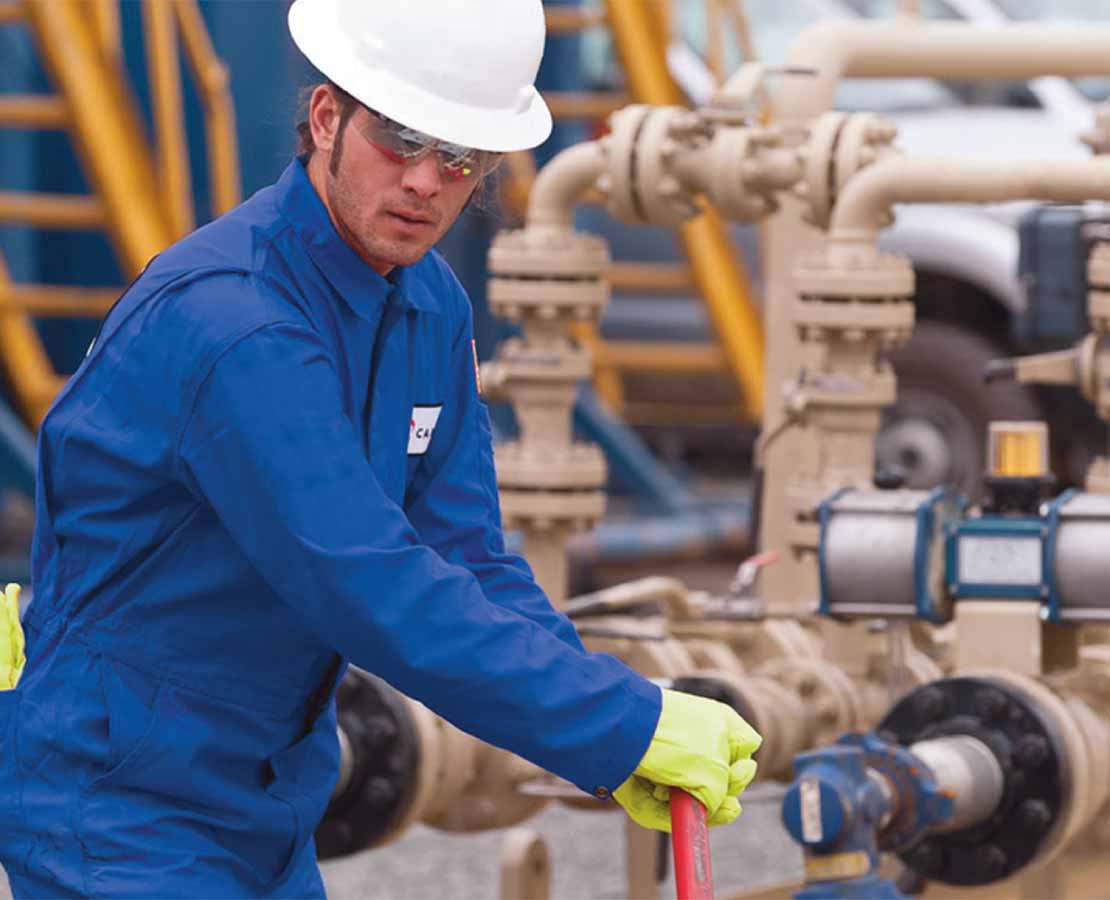 Cameron field technician tightening valve in the field.