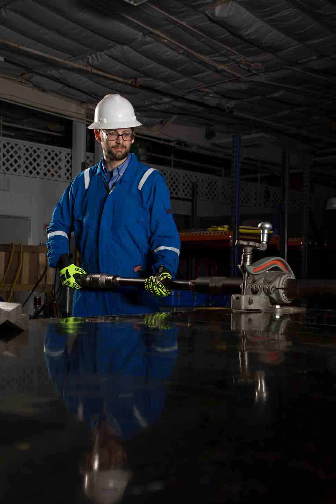 Schlumberger Employee in a lab holding the ACTive Xtreme tool.