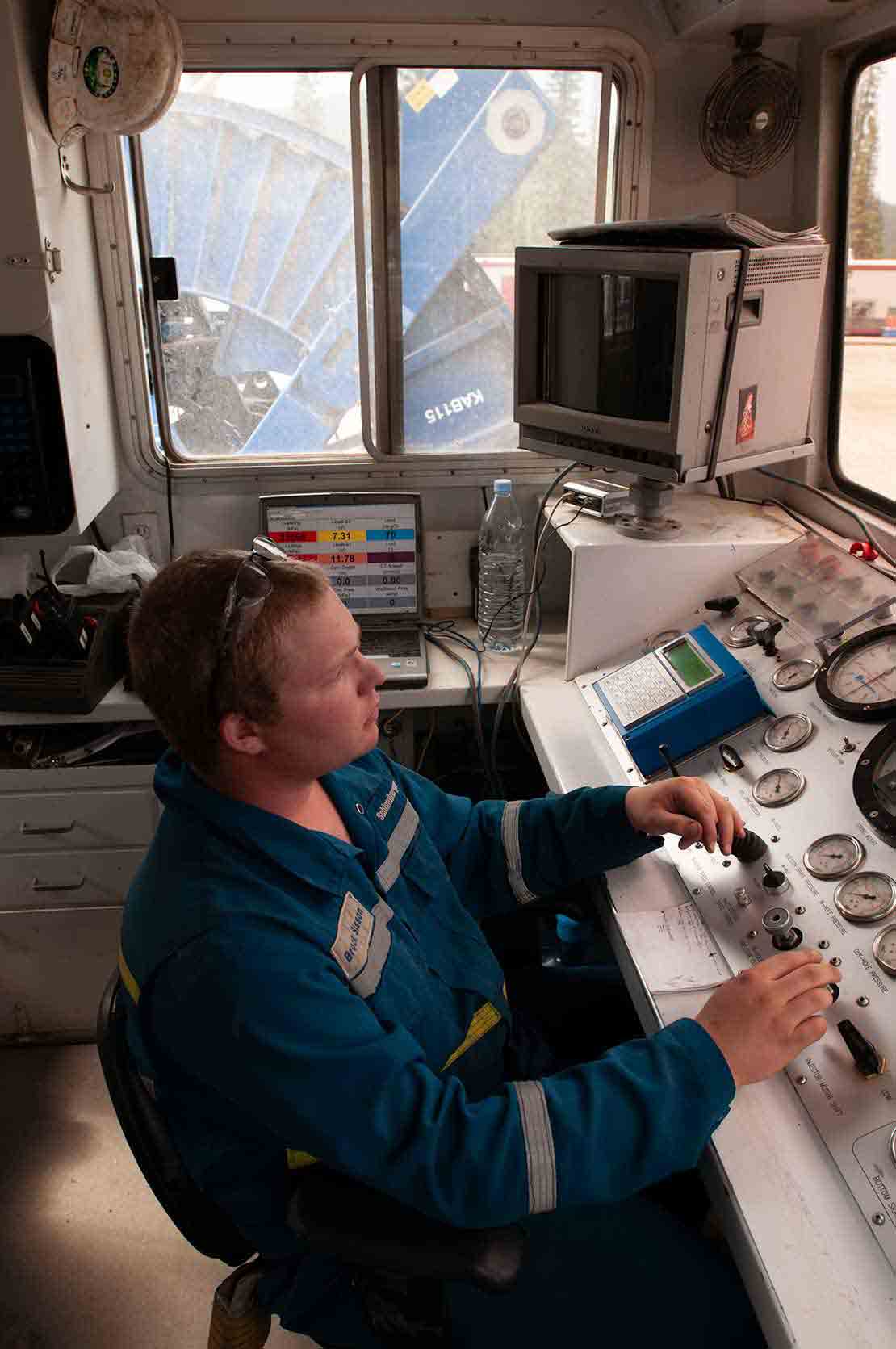 Man in a control cabin for a coiled tubing system.
