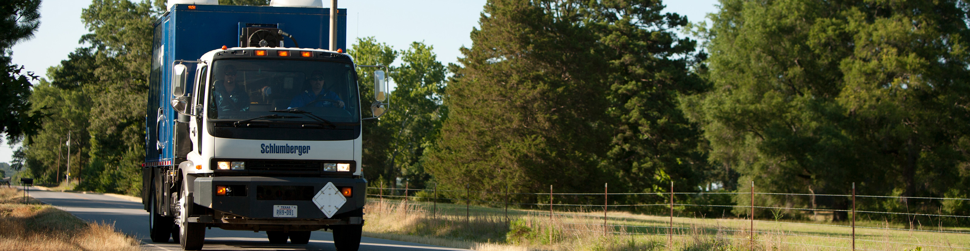 Schlumberger mechanical intervention truck driving down a road.